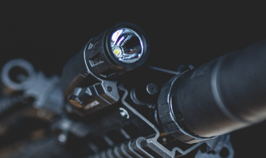 INFORCE weapon light mounted on a rifle in low-light conditions